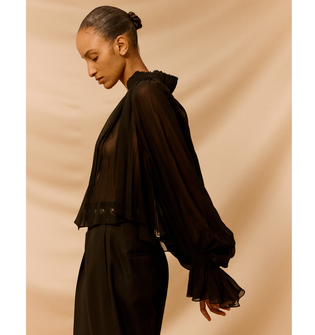 Image 4 of 5 - BLACK - KHAITE Durer Top featuring fluidly formed shirt framed by a high stand collar, cutaway silhouette with hand-crushed cartridge pleating and billowing sleeves cinched at the wrist. 100% silk. 