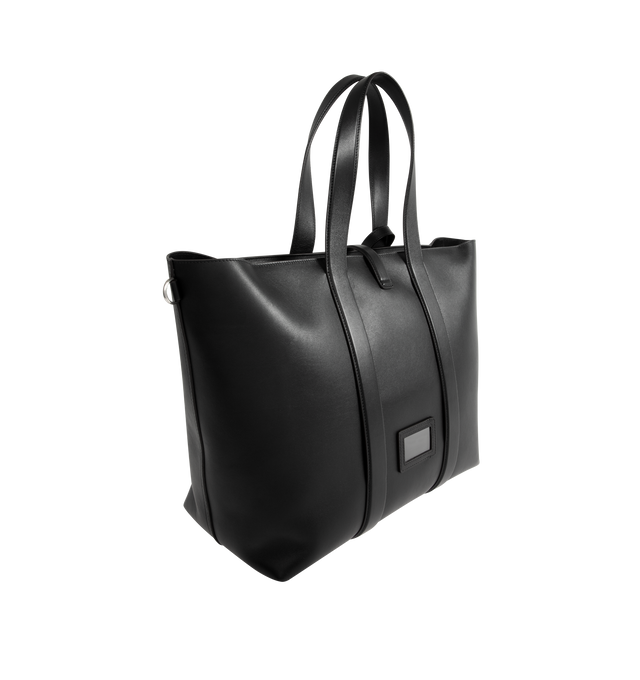Image 2 of 3 - BLACK - Moncler x EE72 by Edward Enninful EE Leather Tote featuring leather lining, leather handles, zipper and buckle closure, front and inner pockets, side bands, name tag and metal loops at each side. L 40 cm x H 57 cm x D 18 cm. Leather. Made in Italy. 