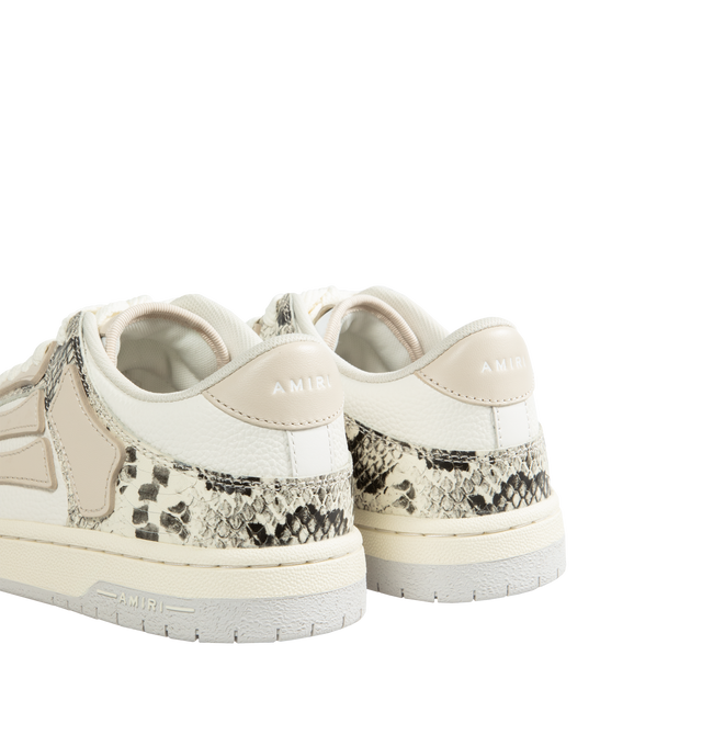 Image 3 of 5 - WHITE - AMIRI Skel Snake-Embossed Low-Top Sneakers featuring matte and snake-embossed leather, flat heel, round toe, lace-up vamp, logo on the tongue and heel, padded collar, skeleton motif on the side and rubber outsole.  