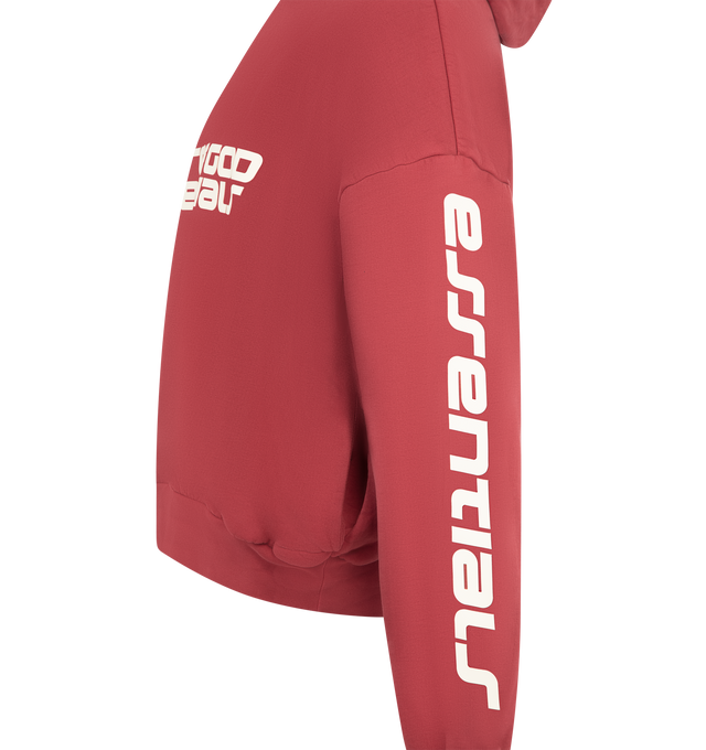 Image 3 of 3 - RED - FEAR OF GOD ESSENTIALS Cropped Relaxed Hoodie featuring 520gsm heavy fleece that's pigment-dyed, a cropped, relaxed silhouette, exaggerated proportions with dropped shoulders, HD-printed graphics, including a Fear of God Essentials lockup across the front and Essentials along the arms, kangaroo pocket, rib-knit trim at the cuffs, and waist hem and a Fear of God Essentials rubberized label stitched to the hood. 100% cotton. 