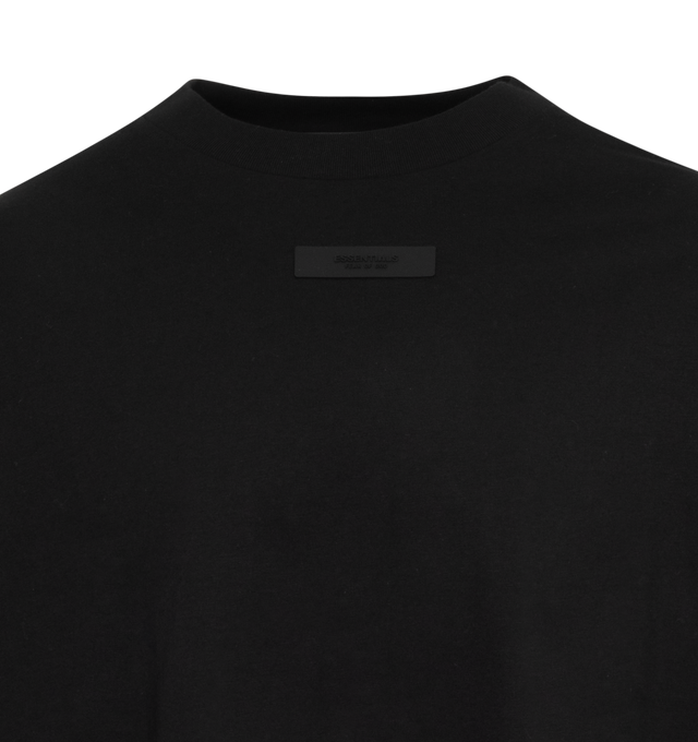 Image 2 of 2 - BLACK - FEAR OF GOD ESSENTIALS Crewneck Long Sleeve T-Shirt featuring rib knit crewneck and cuffs, rubberized logo patch at chest and back and dropped shoulders. 100% cotton. Made in Viet Nam. 