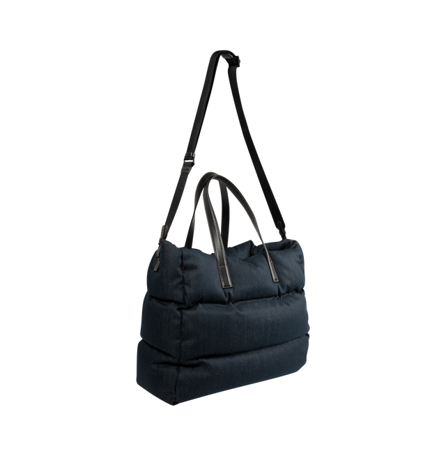 Image 2 of 3 - BLUE - Moncler Mens New Caradoc Tote Bag is crafted from denim with signature boudin quilting inspired by Moncler puffer jackets. Features leather trim and handles, adjustable and detachable shoulder strap, clasp closure, interior zip pocket, metal logo, and down-filled construction. Exterior: 75% Cotton, 24% Polyester, 1% Elastane/Spandex; Lining: 100% Cotton; Padding: 90% Down, 10% Feather; Leather Inserts: Calf Leather. Dimensions: 45cm L x 35cm H x 20cm D. Made in Romania. 