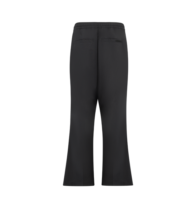 Image 2 of 3 - BLACK - Fear of God Essentials Mens Pleat Front Drawstring Pants are crafted from cotton canvas. Feature a relaxed fit with a relaxed leg and seat, front pleats, elasticized waistband with heavyweight drawstring, side-seam pockets, back welt pockets, and an Essentials signature label. Main Material: 100% Cotton Canvas. 