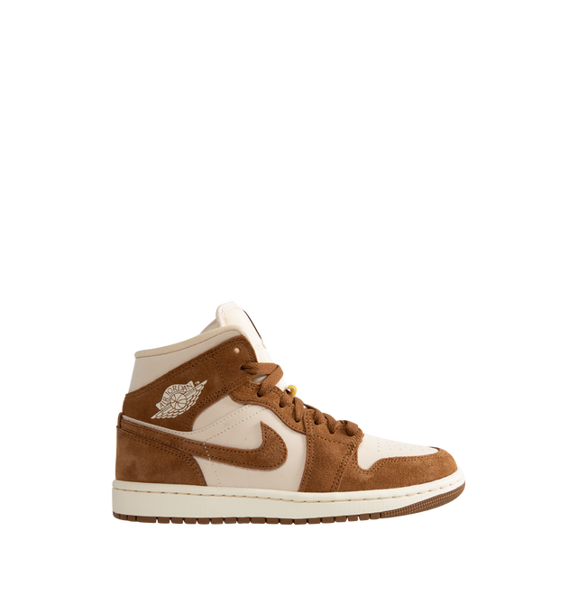 Image 1 of 5 - BROWN - Women's Air Jordan 1 Mid Sneakers feature a genuine and synthetic leather upper with a classic mid-top silhouette for durable comfort and timeless style. Inspired by the iconic original, these lifestyle sneakers combine lightweight Air-Sole cushioning, a padded collar, and a durable rubber outsole for everyday support and reliable traction. Main Material: Genuine Leather and Synthetic Leather. Midsole: Foam with Air-Sole Unit. Sole: Rubber. 