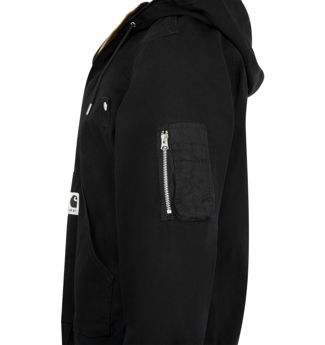 Image 3 of 3 - BLACK - SACAI X CARHARTT WIP Washed Duck Hooded Jacket featuring drawstring hood, drop shoulders, long sleeves, sleeve zip pocket, split kangaroo pocket, rib-knit trim and two-way front zip closure. 100% cotton. 100% nylon. Made in Japan. 