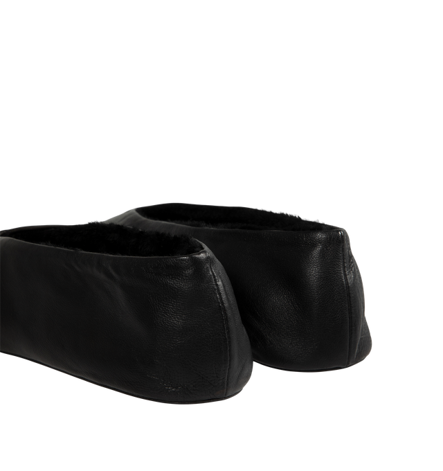 Image 3 of 4 - BLACK - The Row Women's Stella Slippers are crafted from smooth nappa lambskin leather and feature a slip-on silhouette with an oval toe, soft shearling lining, and a flexible rubber-coated sole. These designer leather slippers combine exceptional Italian craftsmanship with luxurious comfort, making them an elevated choice for effortless everyday wear. Main Material: 100% Lambskin Leather. Lining: Shearling. Sole: Rubber-Coated. Made in Italy. 