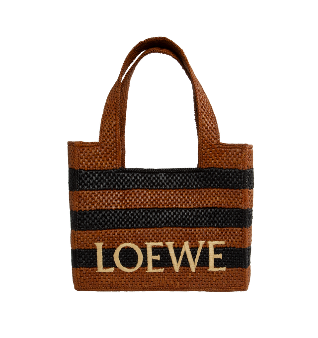 Image 1 of 3 - BROWN - Loewe Paula's Ibiza Logo Front Tote with Stripes is a cuboid bag adorned with a contrasting LOEWE signature. This medium version features two-tone stripes and is made in Spain using raffia palm that is cultivated, harvested, sun-dried and woven in Madagascar by local artisans. Features detachable and adjustable shoulder strap  for hand carry or shoulder carry.  Height (inch): 10 X Width (inch): 11.8 X Depth (inch): 5.9. Made in Portugal.Loewe Paula's Ibiza 2024 collection is inspired  