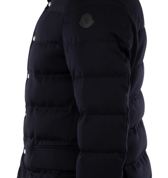 Image 3 of 3 - NAVY - MONCLER Bess Short Down Jacket featuring woven wool gabardine, nylon lger lining, down-filled, pull-out, adjustable rainwear hood with elastic drawstring fastening and snap buttons, contrasting-colored interior piping, ribbed knit collar, inner front bottom with tricolored detailing, zipper and snap button closure, zipped external and internal pockets and leather logo. 100% virgin wool. Lining: 100% polyamide/nylon. Padding: 90% down, 10% feather. 