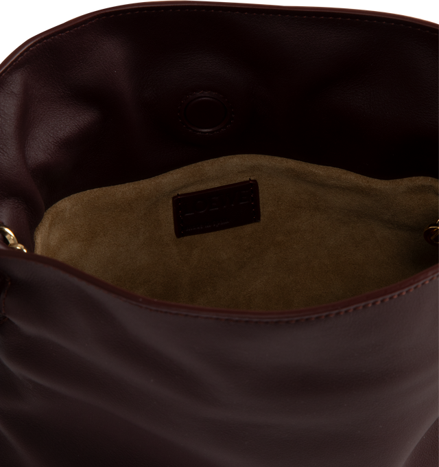 Image 3 of 3 - PURPLE - LOEWE Flamenco Mini Napa Drawstring Clutch Bag featuring suede lining, coiled knot drawstring and hidden magnetic closure. 7"H x 9.4"W x 3.5"D. Convertible shoulder strap: 11 1/2" 23 1/2" drop. Nappa calf. Made in Spain. 