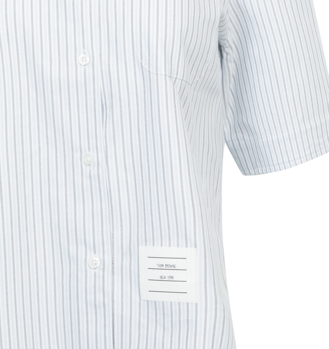 Image 3 of 3 - BLUE - Thom Browne cropped cotton shirt with short sleeves, classic ribbed collar, front button closure, slit pocket on front, iconic brand logo patch applied on front, striped pattern. 100% Cotton. 
