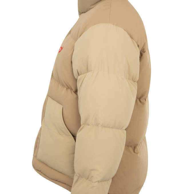 Image 3 of 6 - BROWN - Human Made Down jacket with a voluminous silhouette. The reversible design features a solid color on one side and a crazy pattern on the other, opening up a range of styling options. Material: Nylon. Filling: Down/Polyester. 