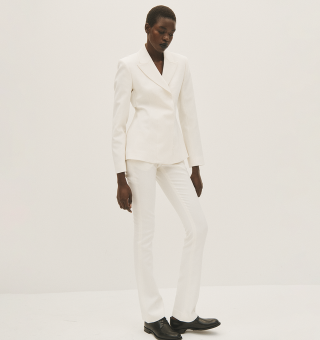 Image 4 of 4 - WHITE - ACNE STUDIOS blazer in white, paneled construction, peaked lapel, structured shoulders, long sleeves, back bra strap embellishment, front concealed double-breasted button closure, straight hem, tailored fit. 