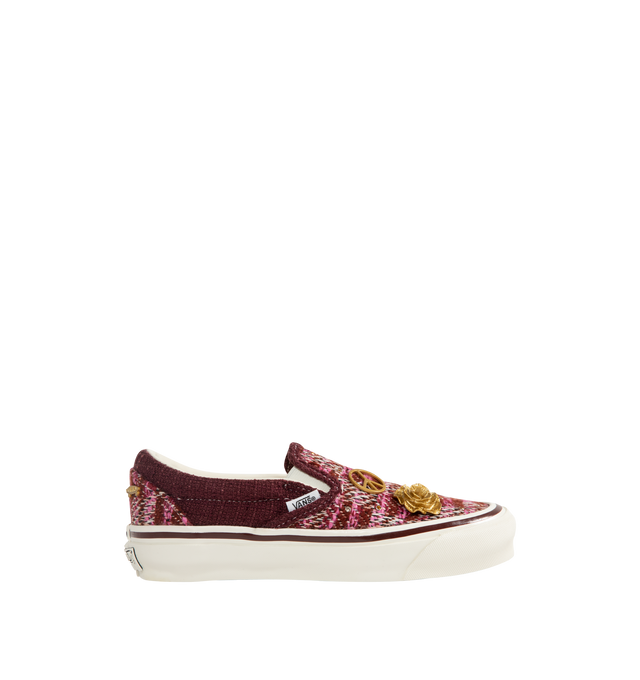 Image 1 of 5 - RED - Vans Unisex Premium LX Classic Slip-On 98 Cardigan Sneakers are crafted from multicolor knit cardigan textile and feature the brand's iconic laceless slip-on silhouette, decorative gold-tone hardware pins, and a padded collar for enhanced comfort. Main Material: Knit Textile; Hardware: Metal Pins; Outsole: Rubber. *Unisex style in men's sizing.   