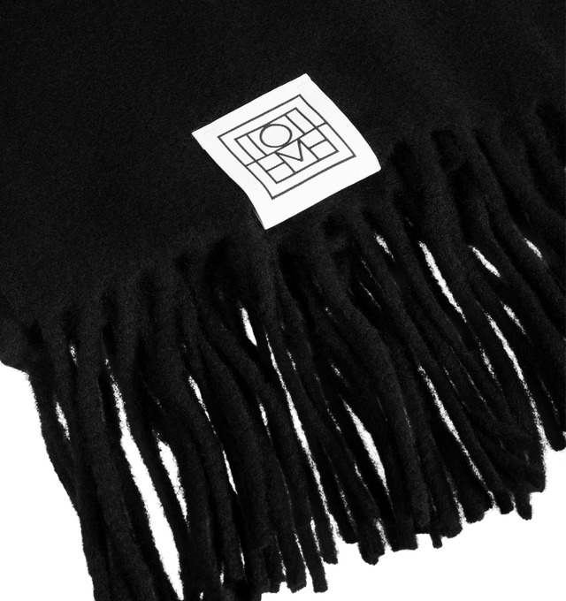 Image 2 of 2 - BLACK - Toteme Women's Fringed Cashmere Blend Scarf is crafted from a luxurious cashmere blend and features a timeless oversized silhouette designed for versatile cold-weather layering. Main Material: 90% Recycled GRS Cashmere, 5% Cashmere, 3% Wool.  
