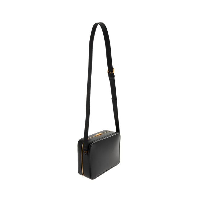 Image 2 of 3 - BLACK - Saint Laurent Men's small everyday case lined in tonal leather, featuring a flat front pocket with debossed SAINT LAURENT PARIS signature. An adjustable strap provides bespoke carry options. Featuring leather lining, bronze-tone hardware, two-way zip closure, one large flat pocket, one flat front pocket and adjustable strap. Measures 8.3" x 6.3" x 2.4" inches with 20.1" handle drop. Calfskin. Made in Italy. 