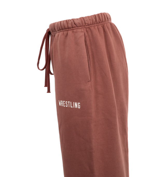 Image 3 of 3 - RED - Fear of God Fleece Drawstring Sweatpants have an elastic drawstring waist, side seam pockets, elastic hems, and logo details. 83% cotton, 17% recycled polyester fleece.  