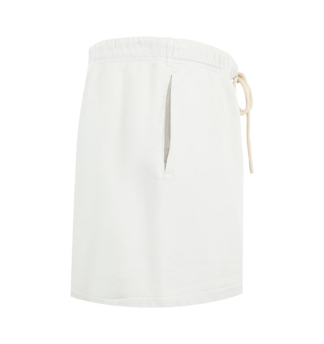 Image 3 of 3 - WHITE - Fear of God Essentials Womens Classic Sweatshorts are crafted from heavyweight cotton fleece with a pigment-dyed finish. Feature a relaxed classic fit, elasticized waistband with adjustable drawcord and bungee, side-seam pockets, and signature Essentials label. Main Material: 100% Cotton. Imported. 