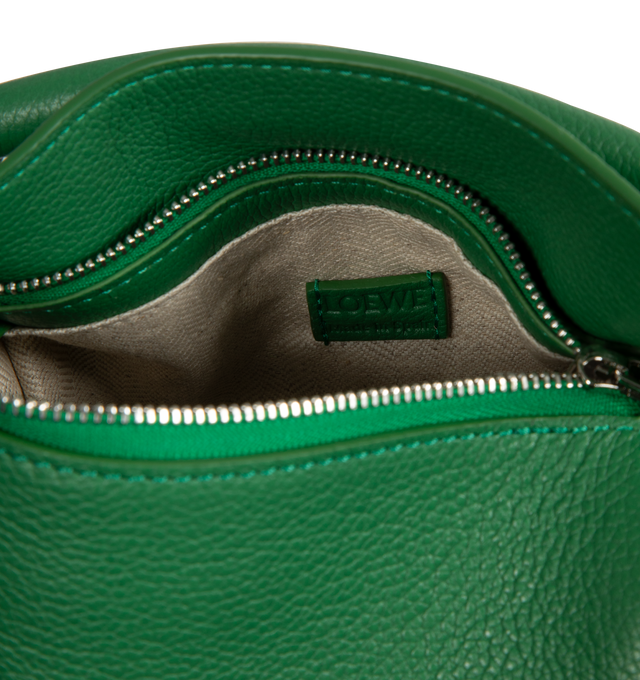 Image 3 of 3 - GREEN - Loewe Mini Puzzle bag in soft grained calfskin featuring a cuboid shape and precise cutting technique create Puzzles distinctive geometric lines. Shoulder, crossbody or hand carry with a detachable and adjustable strap, top handle. Featuring zip closure with calfskin pull, herringbone cotton canvas lining, embossed Anagram. Made in Spain.  