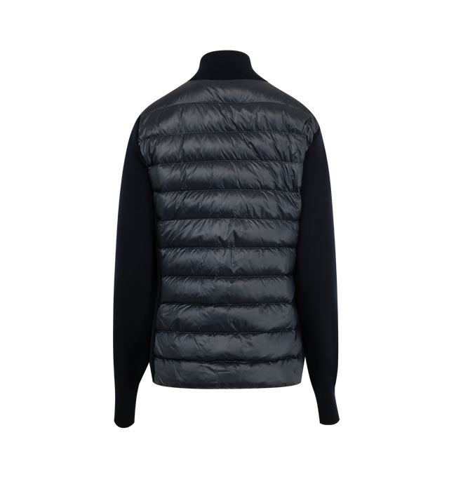 Image 2 of 3 - NAVY - MONCLER Padded Wool Zip-Up Cardigan featuring an attached drawstring hood, front zip closure, channel-quilted body, ribbed cuffs and hem, zip pockets, flap sleeve pocket, and logo patch detail. Lined body and hood. 100% polyamide/nylon. Padding: 90% down, 10% feather. 