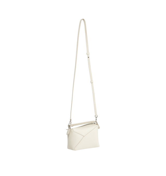 Image 2 of 3 - WHITE - LOEWE Small Puzzle bag featuring removable and adjustable shoulder strap, zip closure with calfskin pull, exterior zip rear pocket and one internal slip pocket, herringbone cotton canvas lining and embossed Anagram. 6.5 x 9.4 x 4.1 inches. 100% Soft Grained Calf. Made in Spain. 