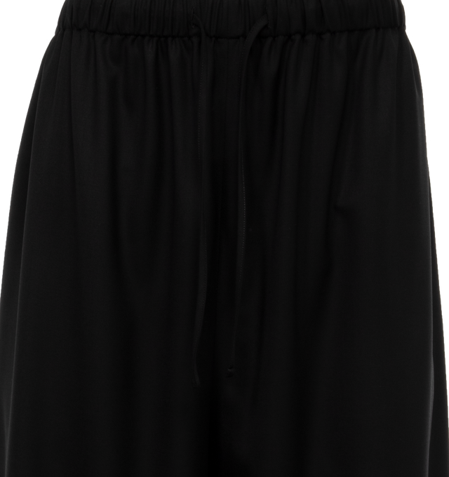 Image 4 of 4 - BLACK - THE ROW Hubert Pant featuring a mid-rise pant in extra fine wool tailoring with tuxedo stripe, drawstring waistband, and side seam pockets. 100% wool. Made in Italy. 