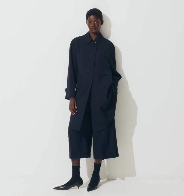 Image 2 of 5 - NAVY - THE ROW Dayton Coat featuring single-breasted car coat in smooth midweight wool gabardine with relaxed knee-length fit, raglan construction, slant welt pockets, and concealed front placket with button closure. 100% wool. Lined in 100% silk. Made in Italy. 
