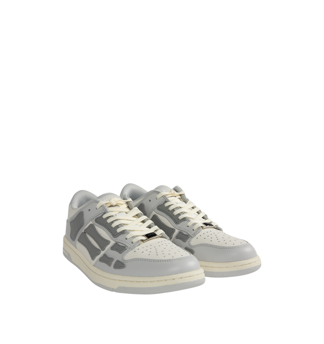 Image 2 of 5 - GREY - AMIRI Skel Top Low Sneakers featuring flat heel, round toe, lace-up vamp, logo on the tongue and heel, padded collar, skeleton motif on the side and rubber outsole. 