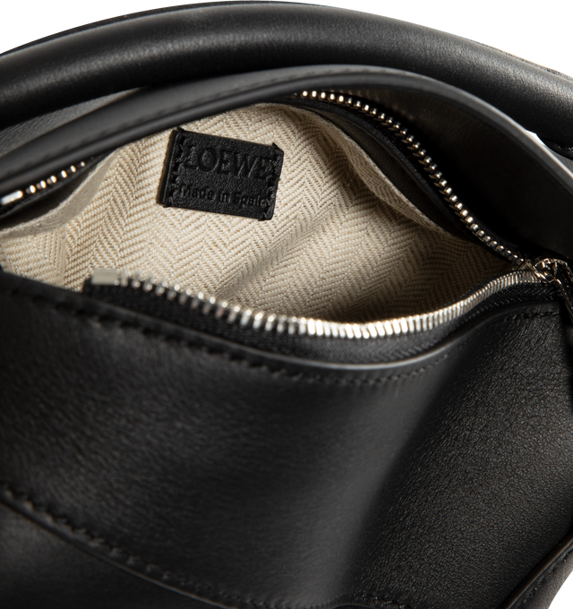 Image 3 of 3 - BLACK - LOEWE Puzzle Edge Mini Bag featuring leather shoulder bag with signature puzzle-piece stitching, rolled top handle, detachable, adjustable shoulder strap and zip top with covered flap. Approx. 2.5"H x 13.3"W x 1.4"D. Made in Spain. 