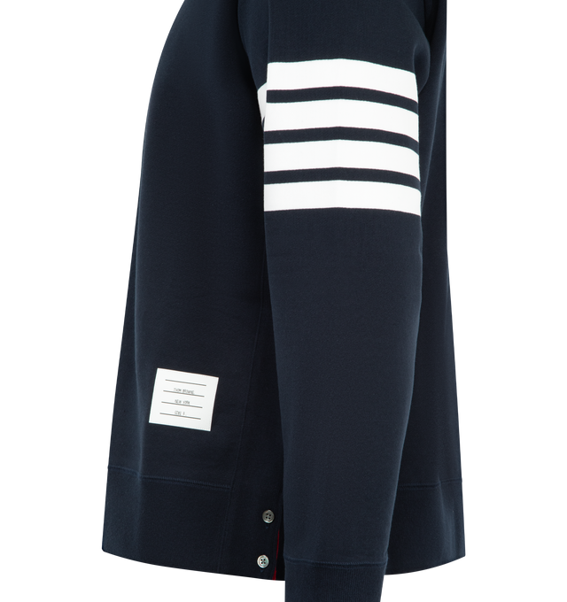 Image 3 of 3 - NAVY - THOM BROWNE Classic Loopback 4 Bar Sweatshirt featuring crew neckline with VPatch, engineered 4-bar stripe detail at left sleeve, name tag applique above hem, buttoned side vents with signature striped grosgrain trim and signature striped grosgrain loop tab at back of neck. 100% cotton. Made in Japan. 