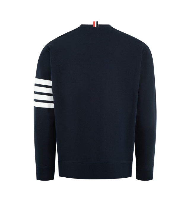 Image 2 of 3 - NAVY - THOM BROWNE Classic Loopback 4 Bar Sweatshirt featuring crew neckline with VPatch, engineered 4-bar stripe detail at left sleeve, name tag applique above hem, buttoned side vents with signature striped grosgrain trim and signature striped grosgrain loop tab at back of neck. 100% cotton. Made in Japan. 