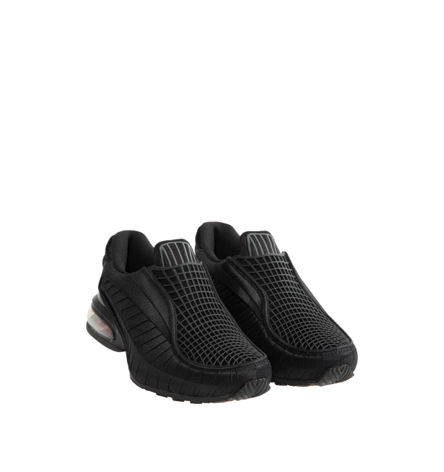 Image 2 of 5 - BLACK - Nike Women's Air Max Dolce Shoes revive an iconic silhouette that seamlessly transitions from casual everyday wear to elevated styling. Originally rooted in performance running, this distinctive design retains the signature details that made it a standout within the Air Max family, including a laceless molded upper, supportive overlay cage, and visible Max Air cushioning in the heel. Finished with a foam midsole for enhanced comfort, the Air Max Dolce delivers lightweight cushioning a 