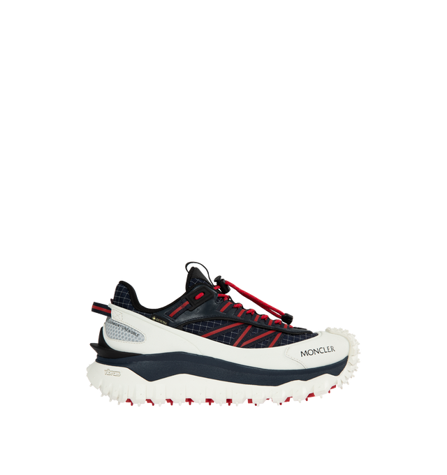 Image 1 of 5 - RED - Designed to accompany you on outdoor activities, the Trailgrip GTX trainers provide comfort and stability. Crafted from reflective ripstop, the trainers are enhanced with a waterproof GORE-TEX membrane. An EVA midsole adds flexibility and lightness, while the Vibram MEGAGRIP treaded sole makes the trainer adaptable to any terrain and offers great traction and high durability. The carbon fiber between the midsole and tread helps propulsion, allowing you to go further. An easily washable  