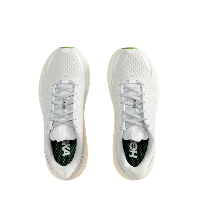 Image 5 of 5 - WHITE - Hoka Unisex Clifton UTL Sneakers feature a breathable mesh upper in Cosmic Grey and Cilantro with raised, textured polyurethane-molded detailing. Reflective laces and webbing accents complete the protective design, while a plush CMEVA midsole and Durabrasion rubber outsole provide cushioned support and durability. Upper: Mesh and Polyurethane. Midsole: CMEVA. Sole: Rubber. *Unisex style in men's sizing. 