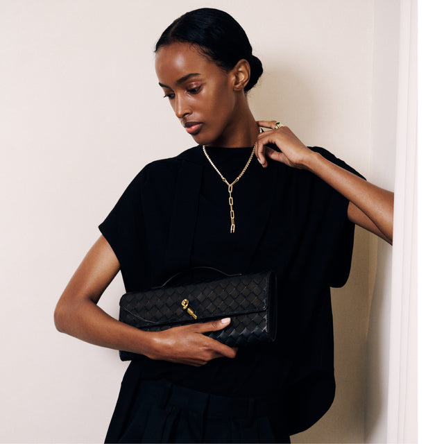 Image 4 of 4 - BLACK - Bottega Veneta Andiamo Intrecciato Suede Clutch is crafted from calfskin suede leather in the iconic signature Intrecciato weave. Featuring a top handle, metal knot closure, six card slots, and an additional interior pocket. This designer suede clutch combines iconic Bottega Veneta craftsmanship with functional organization for day-to-evening wear. Dimensions: 13 cm H x 31 cm W x 3 cm D (5.1" H x 12.2" W x 1.2" D). Fits a large phone, card case, and keys. Lambskin, calfskin. Made i 
