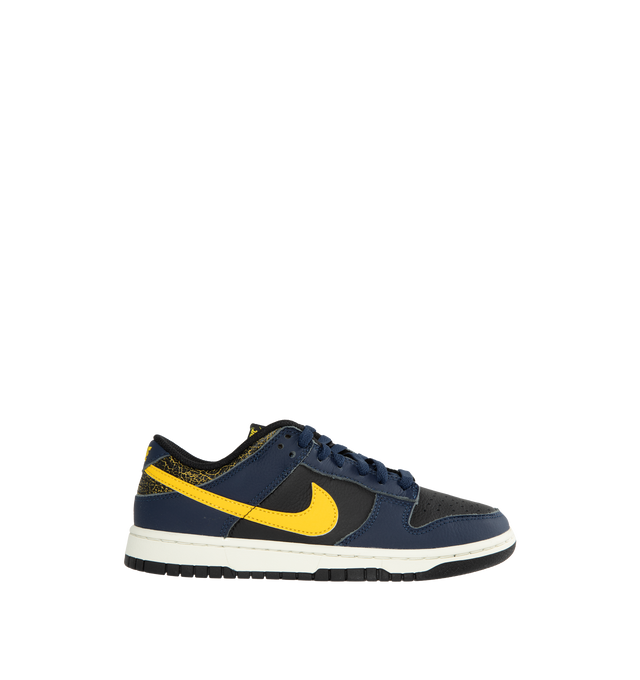 BLACK - NIKE Dunk Low Vintage Michigan Edition featurig leather upper, aged/cracked accents, padded low cut collar, foam midsole and rubber outsole.
