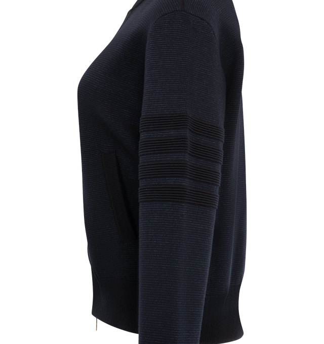 Image 3 of 3 - NAVY - Thom Browne Women's Ottoman Milano Stitch 4-Bar Bomber Jacket is crafted from wool and features the brands signature 4-bar detailing rendered in a raised ottoman-stitch construction along the sleeve. Designed with a refined bomber silhouette, the jacket is finished with a two-way zip closure, rib-knit bomber collar, cuffs, and hem, and welt hand pockets with rib-knit trim. Thom Brownes signature striped grosgrain loop tab completes the design. Main Material: Wool. Made in Italy. 