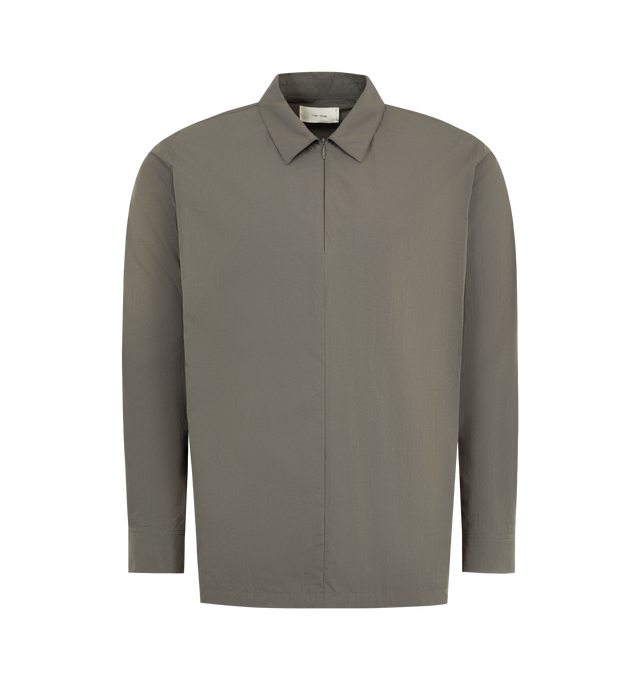 Image 1 of 3 - BROWN - THE ROW Thom Pantsenan Shirt featuring concealed button closure, button cuffs, classic collar, side slit pockets and straight hem. Made in Italy. 