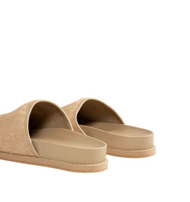 Image 3 of 4 - NEUTRAL - Amiri Mens Clog Slides are crafted from embossed suede leather material. Feature a closed upper, tone-on-tone engraved monogram motif, tapered wraparound construction, and flat rubber outsole with a lightly lugged tread. Upper: Suede Leather; Outsole: Rubber. Made in Vietnam. 
