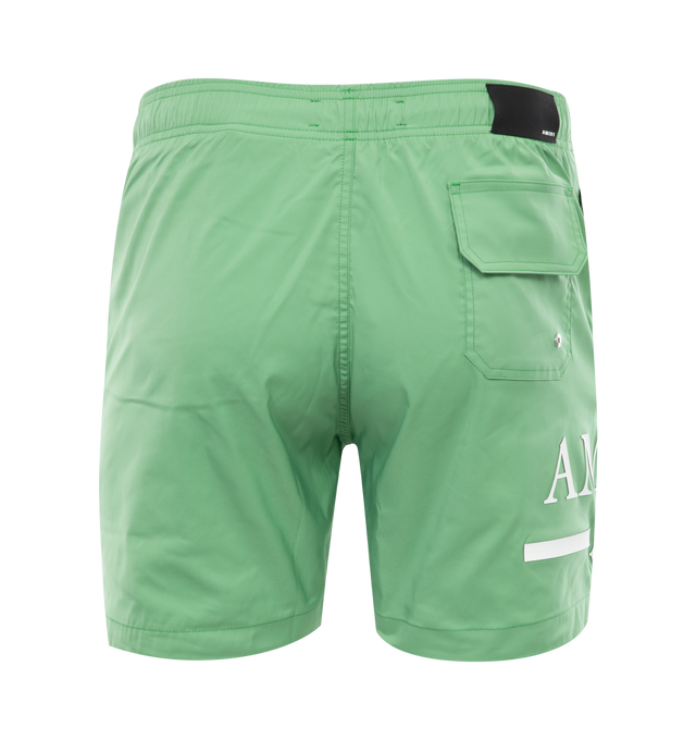 Image 2 of 3 - GREEN - AMIRI MA Bar Logo Swim Trunk featuring drawcord at waist, logo at leg, cover back patch pocket, zipped side pockets and classic fit. 90% polyester, 10% spandex. 