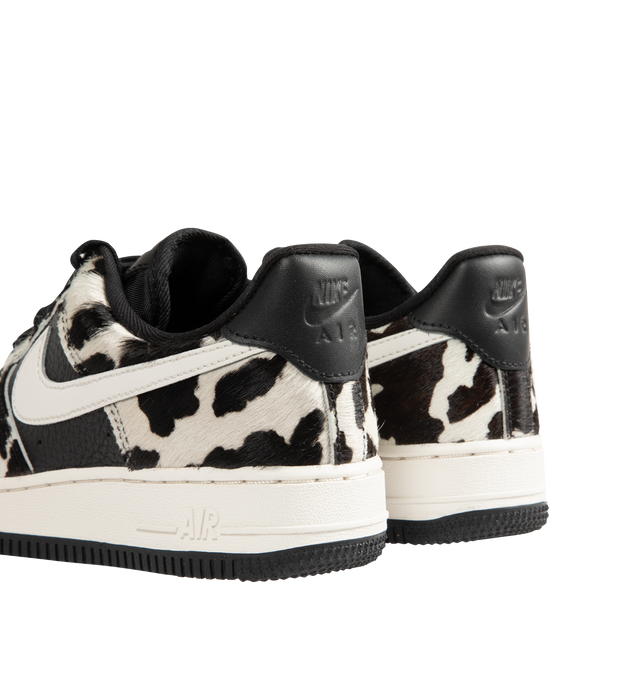 Image 3 of 5 - MULTI - Nike Womens Air Force 1 Low "Cow Print" Sneakers feature a leather upper with cow-print hair overlays. Designed with a lace-up closure, padded collar, perforated toe box, signature Nike Air cushioning, and durable rubber outsole. Upper: Leather with Cow-Print Overlays; Midsole: Nike Air Cushioning; Outsole: Rubber. Imported 