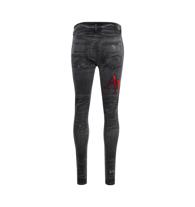 Image 2 of 3 - GREY - AMIRI Staggered Logo Skinny Jeans featuring regular rise, five-pocket style and fitted through skinny legs. Cotton/polyester/elastane. Made in USA. 