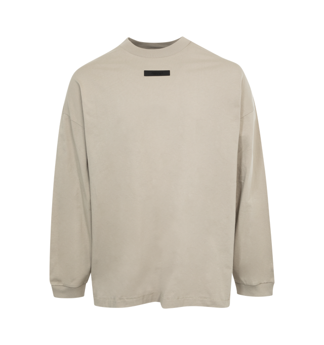 Image 1 of 2 - GREY - FEAR OF GOD ESSENTIALS Crewneck Long Sleeve T-Shirt featuring rib knit crewneck and cuffs, rubberized logo patch at chest and back and dropped shoulders. 100% cotton. Made in Viet Nam. 