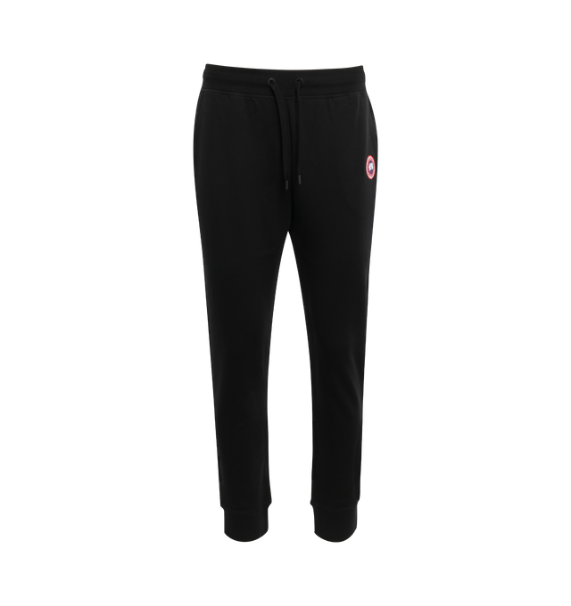 BLACK - CANADA GOOSE Huron Sweatpants featuring tapered leg, low-crotch style, adjustable at the waist, mid-weight and stretchy fabric. 100% cotton. 