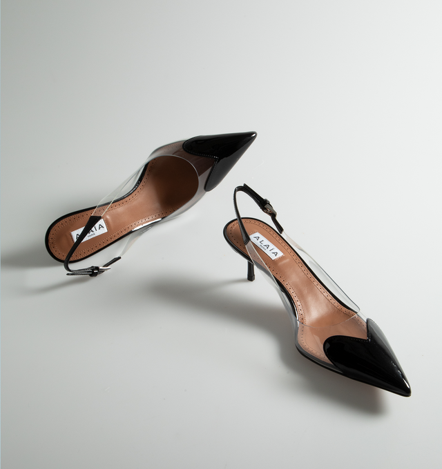 BLACK - ALAIA Heart Slingbacks in Patent Lambskin featuring clear vamp, pointy cap toe with a patent-leather heart and adjustable slingback strap with buckle closure. 55MM. Leather and synthetic upper. Leather lining. Leather and rubber sole. Made in Italy.