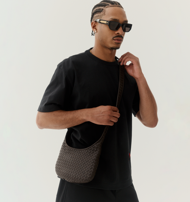 Image 2 of 4 - BLACK - BOTTEGA VENETA Small Veneto Bag featuring cross-body bag with rounded shape, intrecciato nappa leather fluffy, one interior zipped pocket and zipper closure. 6.7" x 10.6" x 1". Lambskin. Made in Italy. 