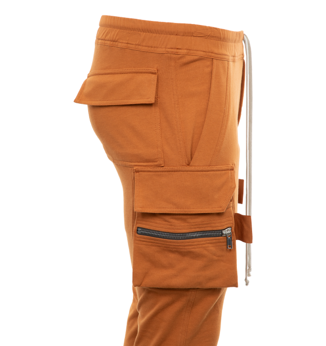 Image 3 of 3 - BROWN - RICK OWENS Mastodon Cargo Sweatpants featuring elasticated drawstring waist, tapered leg, side slit pockets, back pockets and zipped pockets. 100% cotton. 