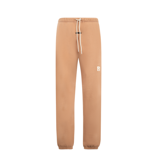 Image 1 of 3 - ORANGE - Fear of God Essentials Mens Classic Sweatshorts are crafted from heavyweight 390 GSM cotton fleece. Feature a classic relaxed fit, elasticized waistband with bungee drawcord, side-seam pockets, pigment-dyed finish, puff-printed F26 graphic, and an Essentials signature label. Main Material: 100% Cotton.  