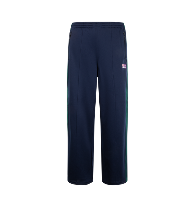 Image 1 of 3 - BLUE - Needles x Fila Men's Ventisei Track Pant is crafted from polyester and features a relaxed track pant silhouette inspired by FILA's sportswear heritage. Designed as part of the first collaboration between Needles and FILA, it is finished with bold color-block detailing, signature branding accents, and an elasticized waistband for everyday comfort. Main Material: 100% Polyester.  