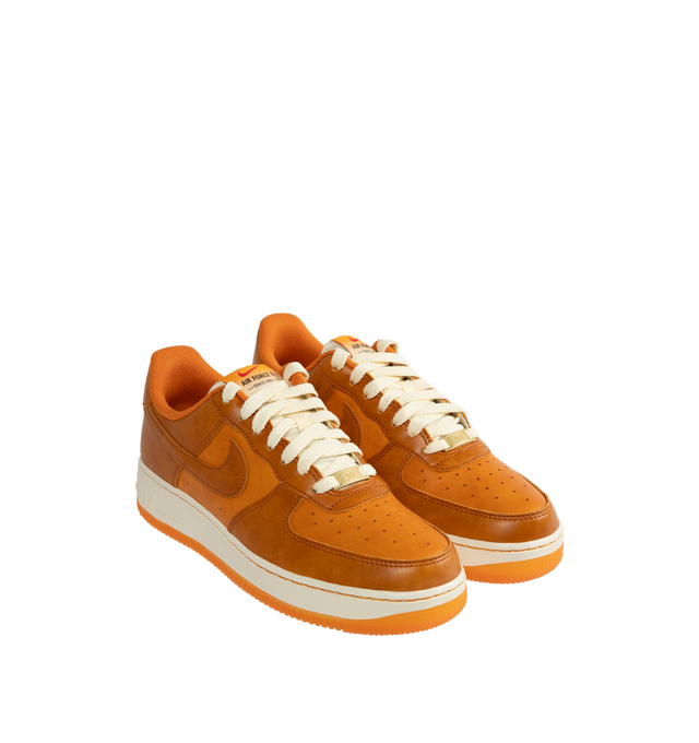 Image 2 of 5 - ORANGE - Nike Air Force 1 '07 LV8 Sneakers are a lace-up style with perforations for ventilation, foam soles, encapsulated Air cushioning, and padded collars.  