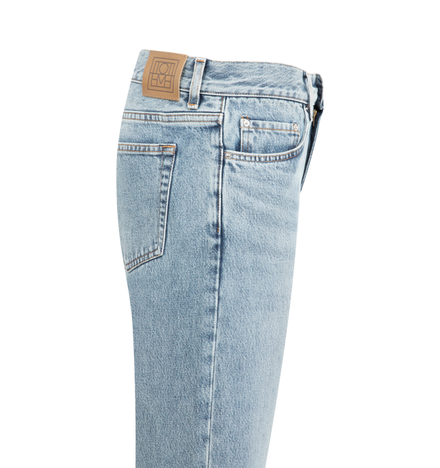 Image 3 of 3 - BLUE - Toteme versatile jeans cut to sit low on the waist and fall into straight legs for a relaxed, masculine silhouette softened by a light true vintage wash. Featuring zipper fly, silver-tone hardware,  five pockets, belt loops, finished hem and leather patch. 100% organic cotton. Made in Italy. 